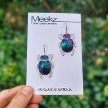 Load image into Gallery viewer, Christmas Beetle Drop Earrings with purple shells on Packaging Card