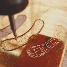 Load image into Gallery viewer, Behind the scenes look of us making I NEED COFFEE ear cuff with the CNC Machine
