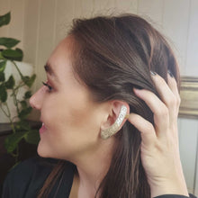 Load image into Gallery viewer, FEED ME ear cuff modelled by Sheridan Eveline posing with her hand