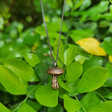Load image into Gallery viewer, Button Mushroom Necklace Hanging above a bush