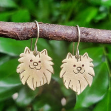 Load image into Gallery viewer, Dog Mini Head Drop Earrings Pomeranian in Brass on Sterling Silver Shepherd Hooks hanging on a branch