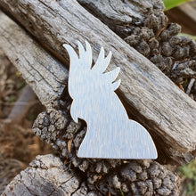 Load image into Gallery viewer, Aluminium Cockatoo Brooch sitting on a wooden fence