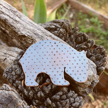 Load image into Gallery viewer, Copper wombat brooch sitting on a wooden fence