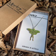 Load image into Gallery viewer, Luna moth necklace hanging on a packaging card in a box