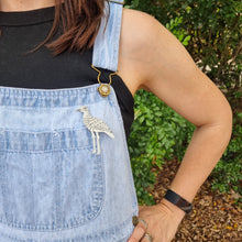 Load image into Gallery viewer, Bush Stone-Curlew Brooch Modelled by Sheridan Eveline on her Overalls
