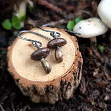 Load image into Gallery viewer, Button Mushroom Drop Earrings on a Wooden Stump  Close Up
