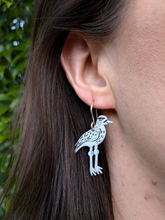 Load image into Gallery viewer, Recycled aluminium curlew drop earrings modelled by Sheridan Eveline.
