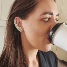 Load image into Gallery viewer, I NEED COFFEE ear cuff modelled by Sheridan Eveline drinking coffee
