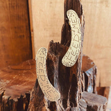 Load image into Gallery viewer, FEED ME ear cuffs close up on a wood stump
