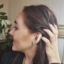 Load image into Gallery viewer, FEED ME ear cuff modelled by Sheridan Eveline posing with her hand

