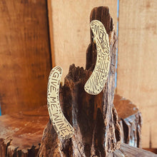 Load image into Gallery viewer, GIVE ME WINE ear cuff on a wood stump details
