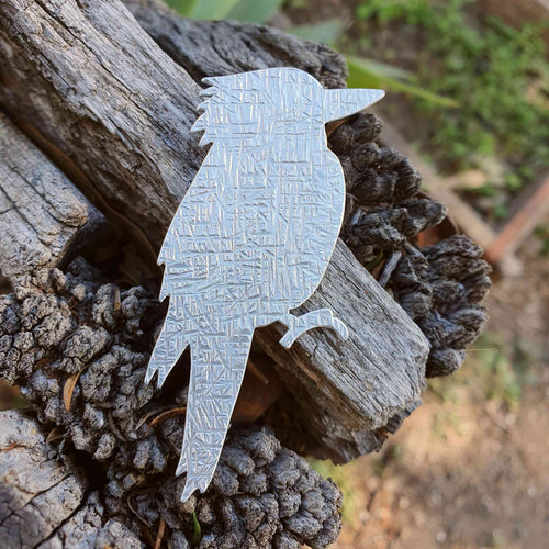 Aluminium Kookaburra Brooch sitting on a wooden fence