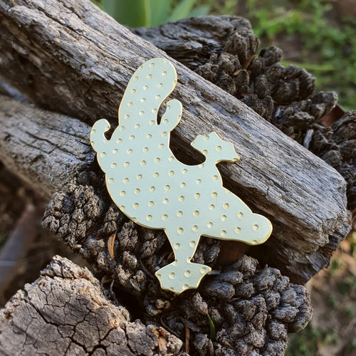 Platypus Magnetic Brooch sitting on a wood fence