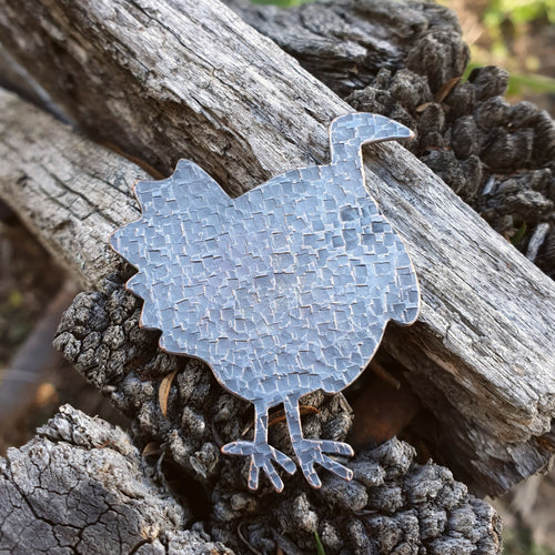 Copper Scrub Turkey with Patina sitting on a wooden fence