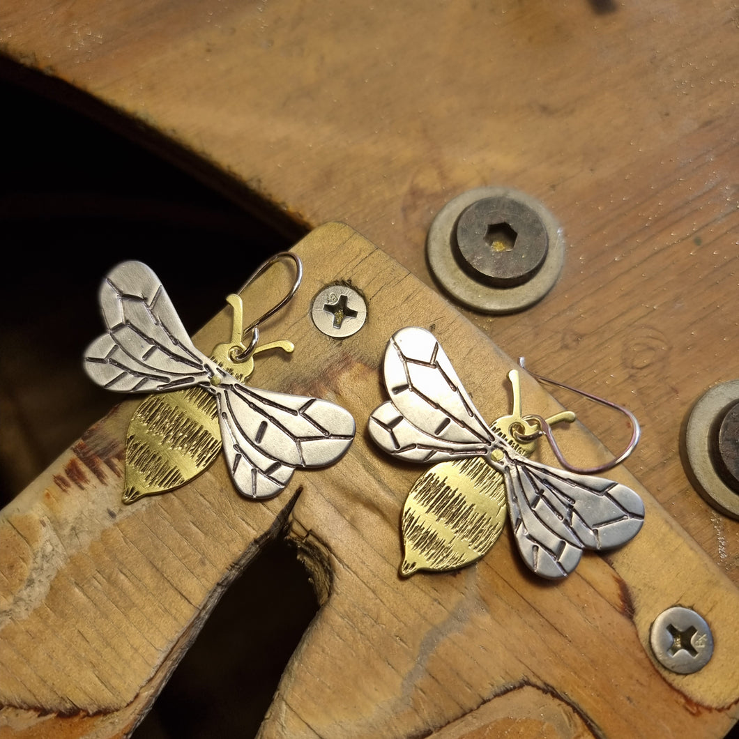 Riveted Bee Earrings on bench