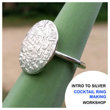 Load image into Gallery viewer, Intro to Silver Cocktail Ring Making Workshop Advertisement - sterling silver cocktail ring with cross hatch texture, photographed on a plant stem.
