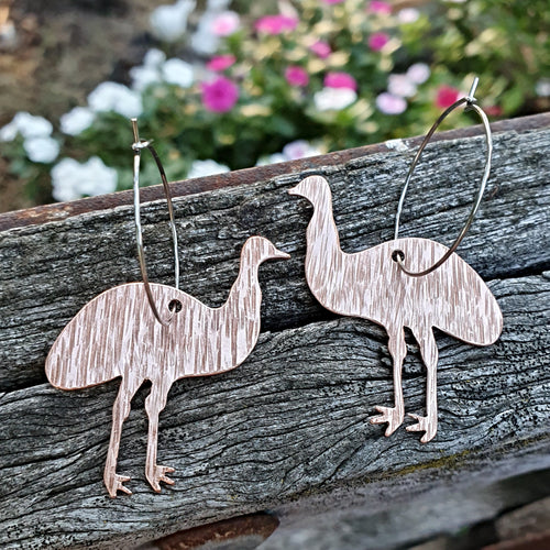 Australiana Emu Hoop Earrings close up on wood