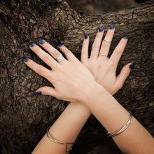 Load image into Gallery viewer, 2mm and 10mm sterling silver rings and sterling silver bangles modelled by chantelle on a tree
